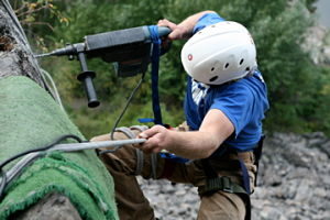 drilling holes for bolts in a cliff